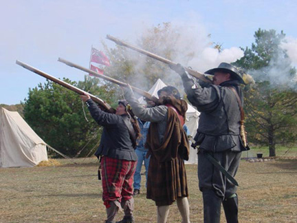 this is a picture of me, my friend Jay, and my other friend Cory. We were demonstrating the Matchock musket drill. In this picture we'd just finished firing and you can see the puffs of smoke coming from the muzzle and slightly drifting off into the wind. That was a great day! All three muskets went off!